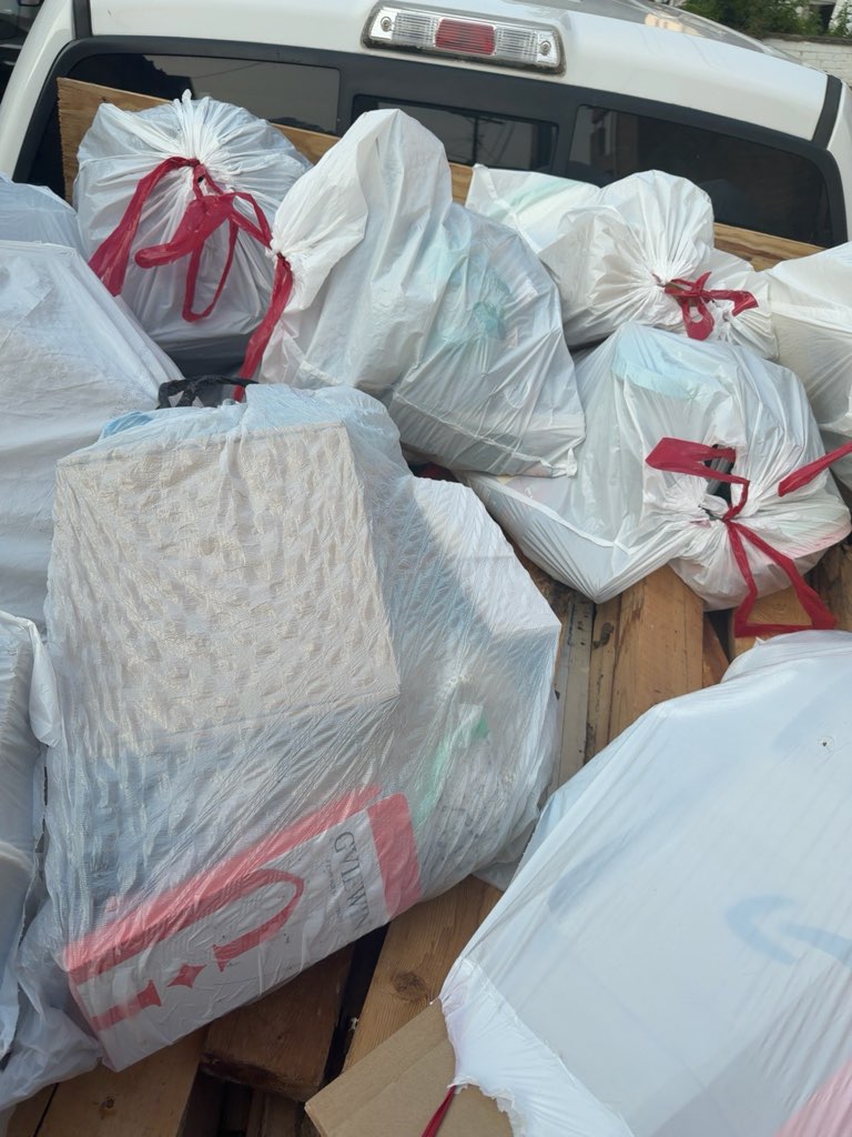 Truck bed packed with bagged household junk ready for disposal