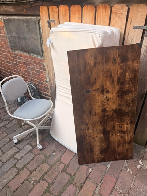 Mattress, tabletop and office chair carried out to the alley
